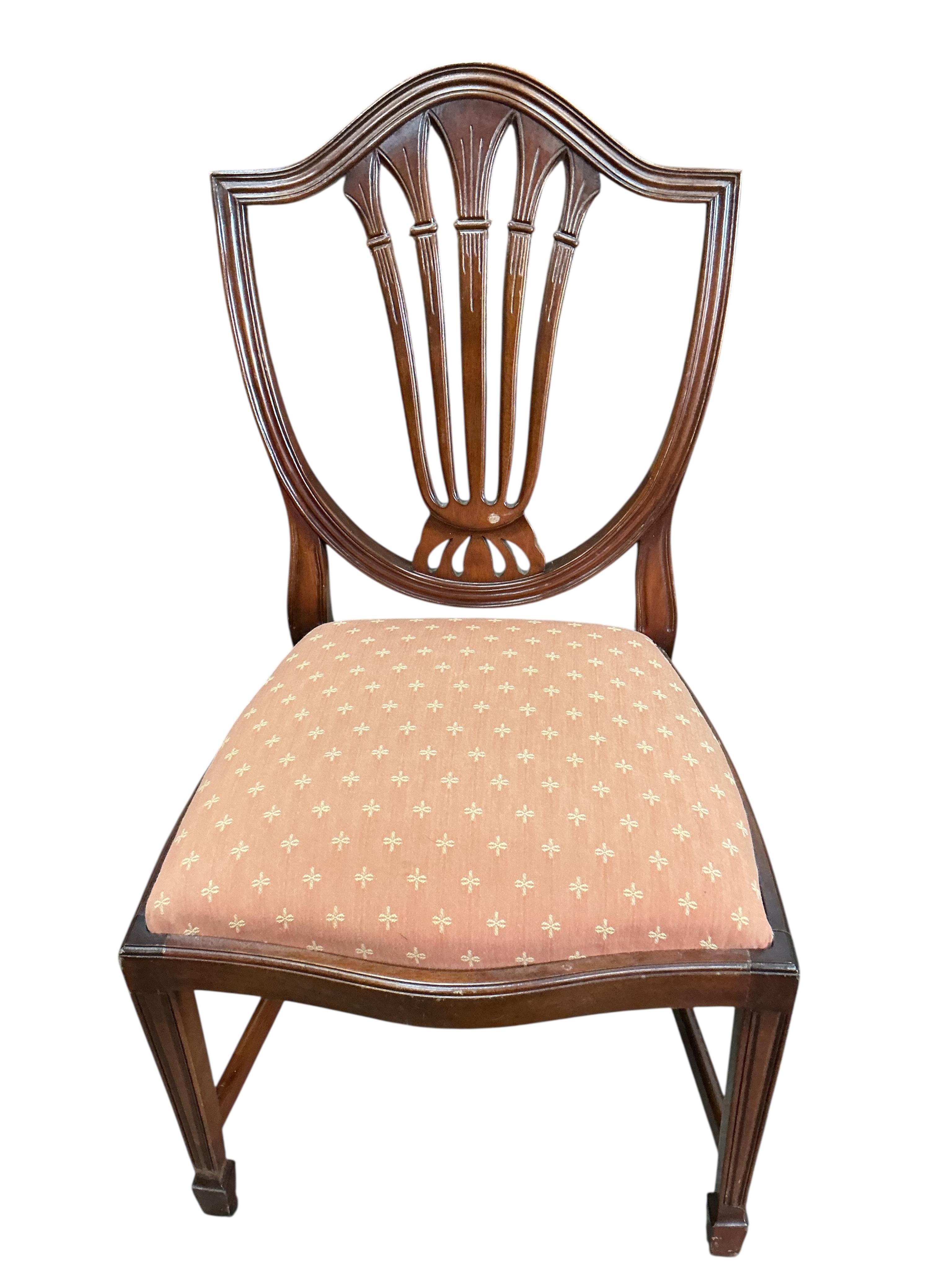 A reproduction mahogany twin pillar extending dining table, 216cm extended, one spare leaf, depth 98cm, height 74cm and eight Hepplewhite style dining chairs, two with arms